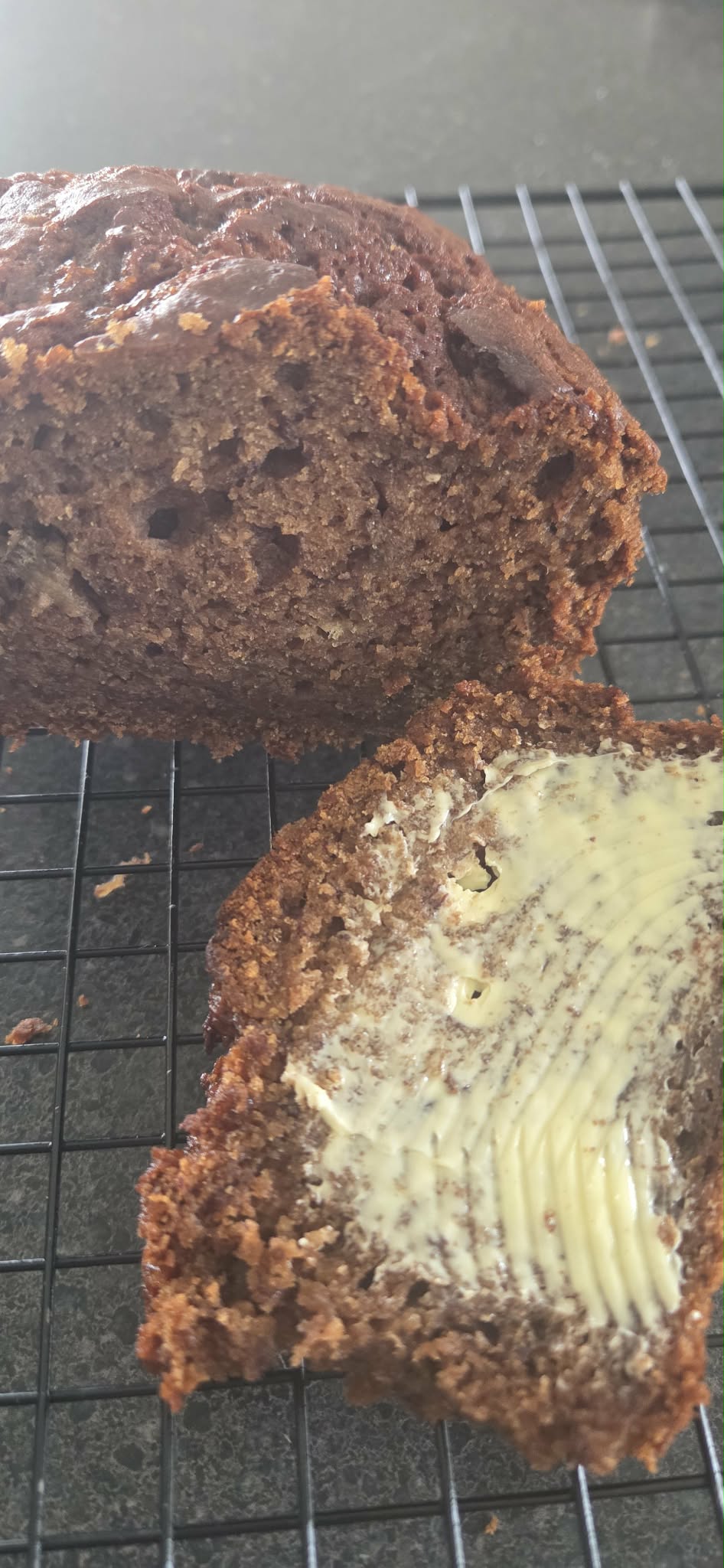A slice of banana bread slathered in butter